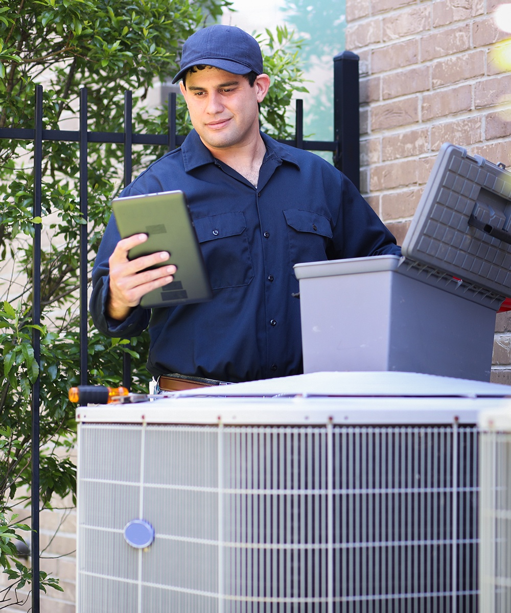 Repairman conducting an residential AC recharge